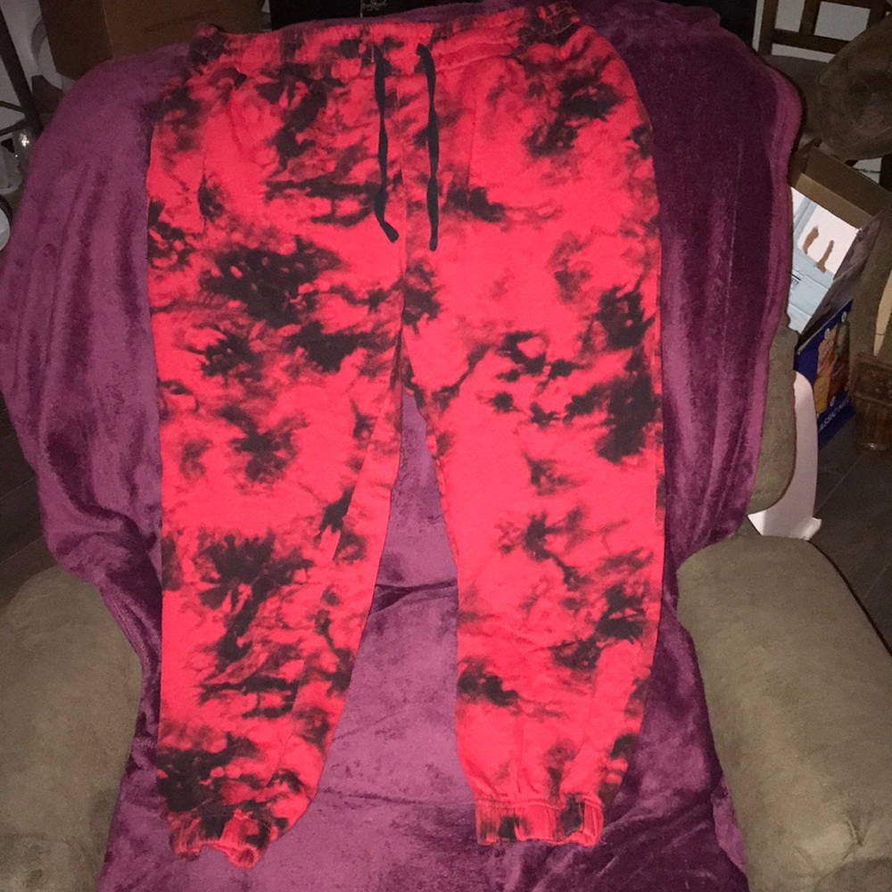 Black and red sweatpants scrunch at the bottom and top with three pockets